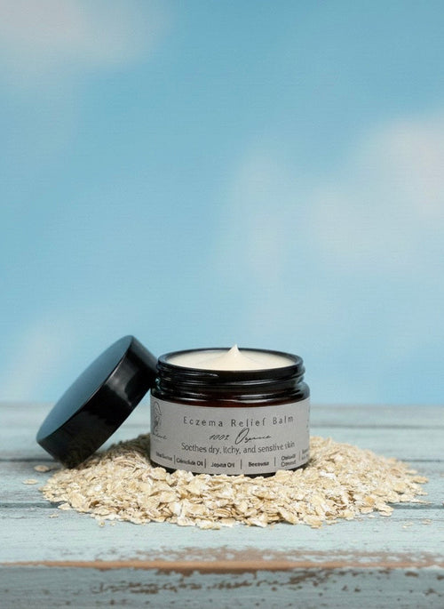 Jar of cream with a lid on a wooden surface against a blue sky