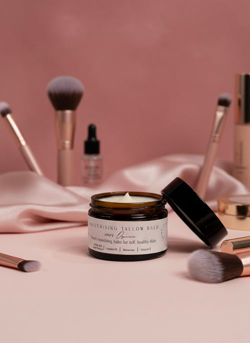 Cosmetic jar with makeup brushes and skincare products on a pink background